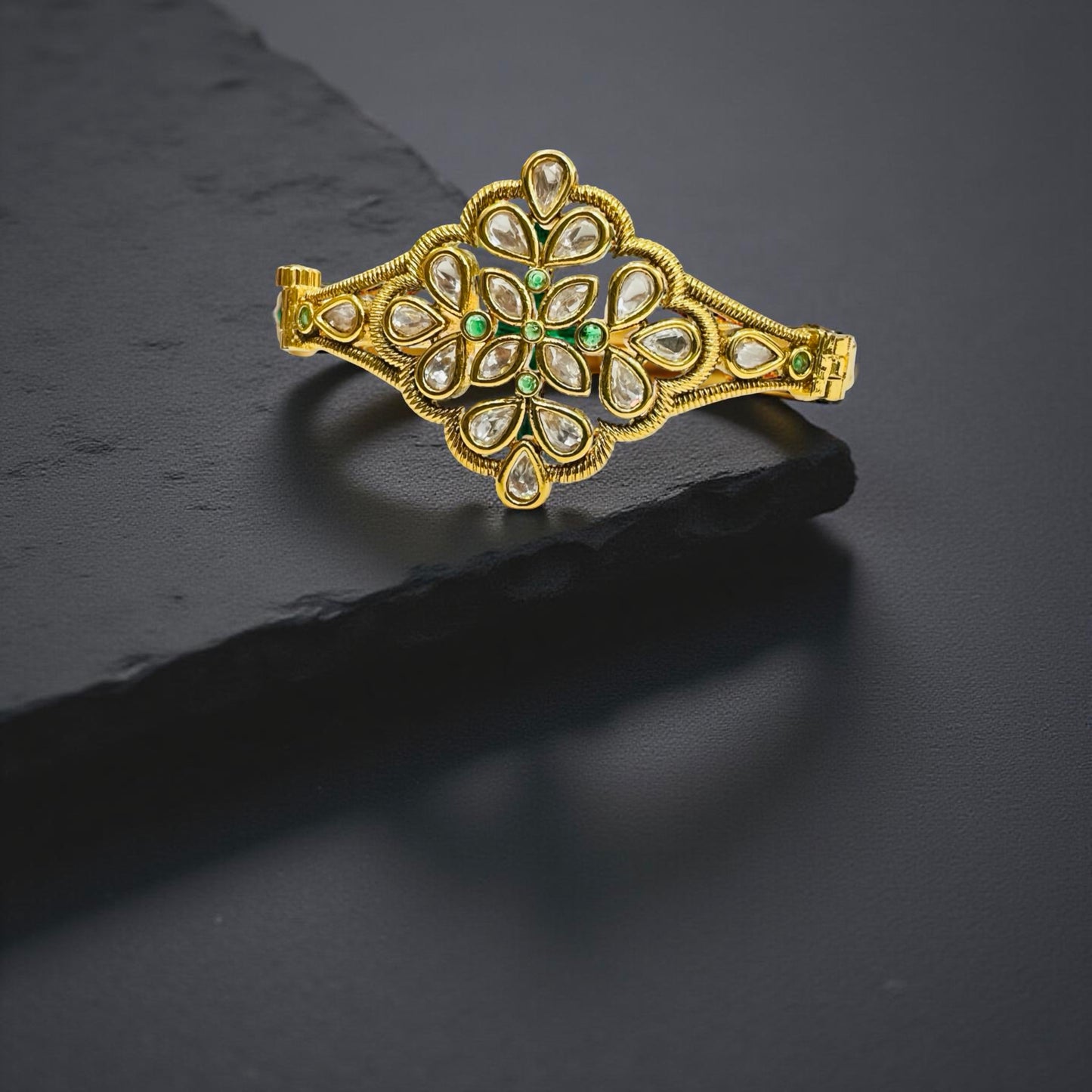 Jinam Royal gold-plated Kundan floral bracelet with intricate design and vibrant gemstone accents.