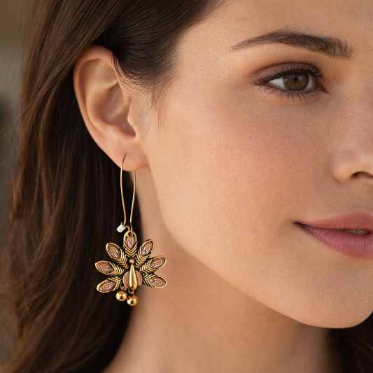 Gold-plated peacock motif hook earrings by Jinam featuring intricate antique design and elegant craftsmanship.
