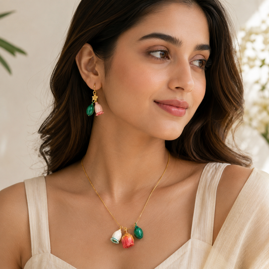 Green stone and pink floral drop earrings close up