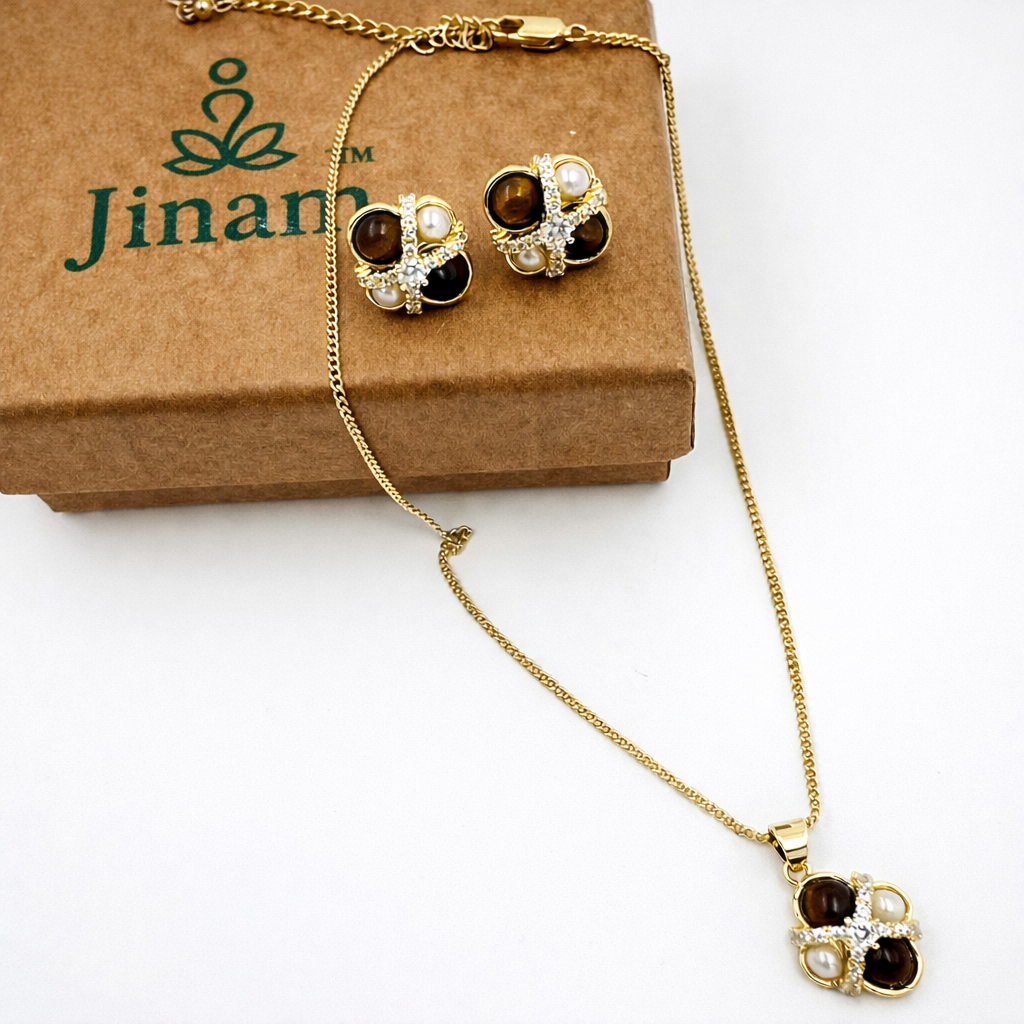Gold-plated tiger eye and pearl pendant necklace set with CZ crisscross design, featuring a stylish and elegant pendant and matching chain.