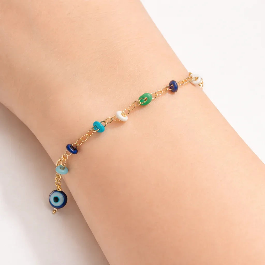 Colorful charm chain bracelet by Jinam featuring vibrant beads and metal charms on a delicate silver chain.