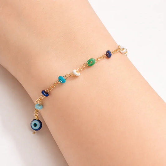 Colorful charm chain bracelet by Jinam featuring vibrant beads and metal charms on a delicate silver chain.