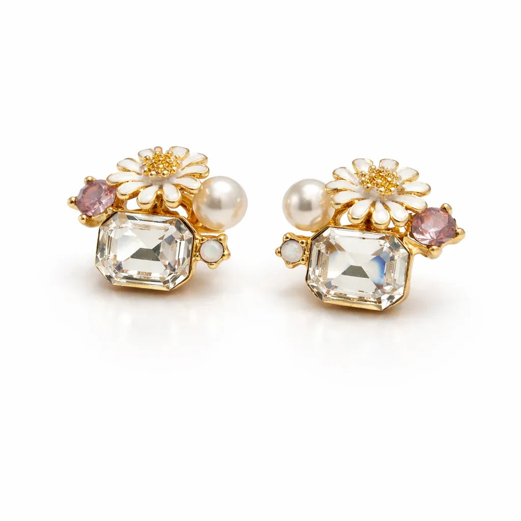 Jinam floral crystal cluster pendant and earrings set with white enamel daisy design, featuring sparkling crystal accents.