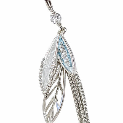 Silver-plated long tassel earrings by Jinam featuring elegant, flowing tassels hanging from sleek hooks.