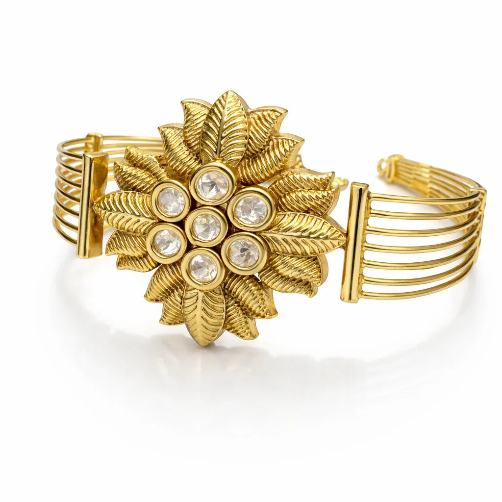 Antique gold floral Kundan statement bracelet with intricate design and gemstone accents by Jinam.
