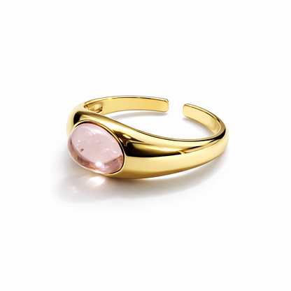 Jinam pink stone statement gold ring with adjustable band, showcasing a vibrant pink gemstone and elegant gold setting.