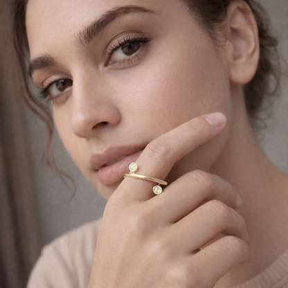 Gold plated dual crystal open band ring by Jinam with adjustable size and elegant design, featuring sparkling crystals on a sleek band.