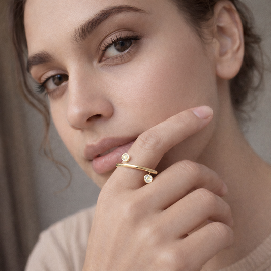 Gold plated dual crystal open band ring by Jinam with adjustable size and elegant design, featuring sparkling crystals on a sleek band.