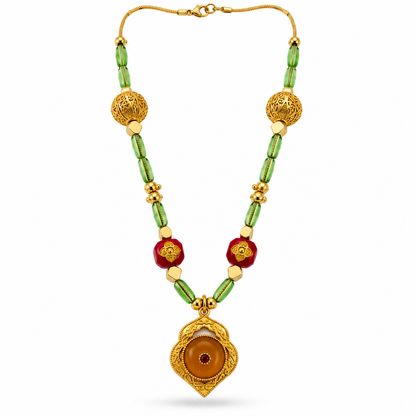 Gold Filigree Ball Necklace with amber ogee pendant and green glass tube beads on white background