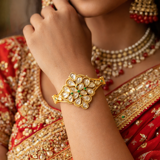 Gold-plated Kundan floral bracelet by Jinam featuring intricate design and elegant floral motifs.