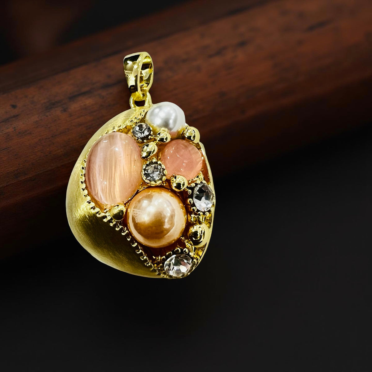 Gold-plated pearl and stone cluster pendant and earrings set by Jinam, featuring elegant jewelry with intricate design and vibrant stones.