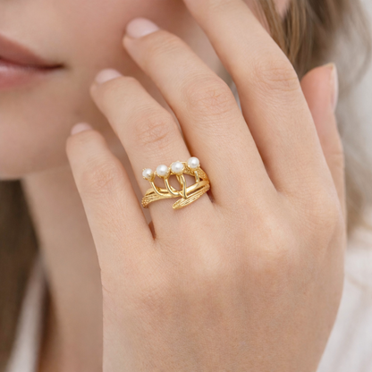 Jinam Golden Bloom Pearl Branch adjustable ring featuring a delicate pearl and floral design on a gold-tone band.