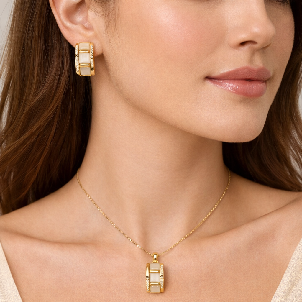 Gold-plated cream cat-eye stone pendant and earrings set by Jinam, featuring elegant jewelry with matching pendant and dangle earrings.