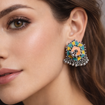 Colorful enamel stud earrings with silver ghungroo detailing by Jinam, showcasing vibrant designs and traditional silver accents.