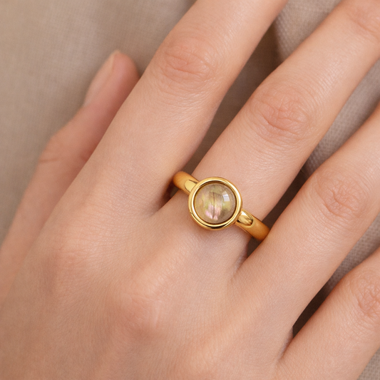 Gold-tone adjustable ring by Jinam featuring a natural iridescent shell stone and minimalist design.