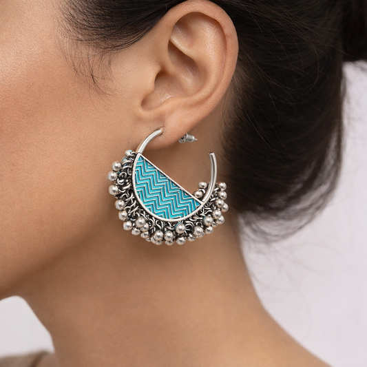 Oxidised silver hoop earrings by Jinam with colorful enamel and bead detailing, showcasing intricate craftsmanship and stylish design.