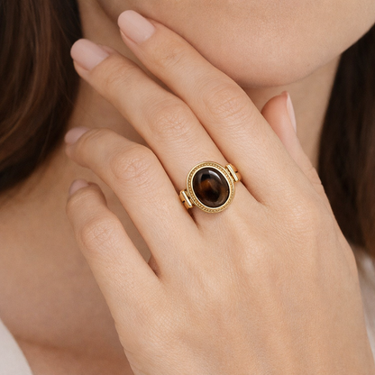 Vintage Tiger Eye oval adjustable ring by Jinam featuring a polished tiger eye gemstone on a silver-toned band.