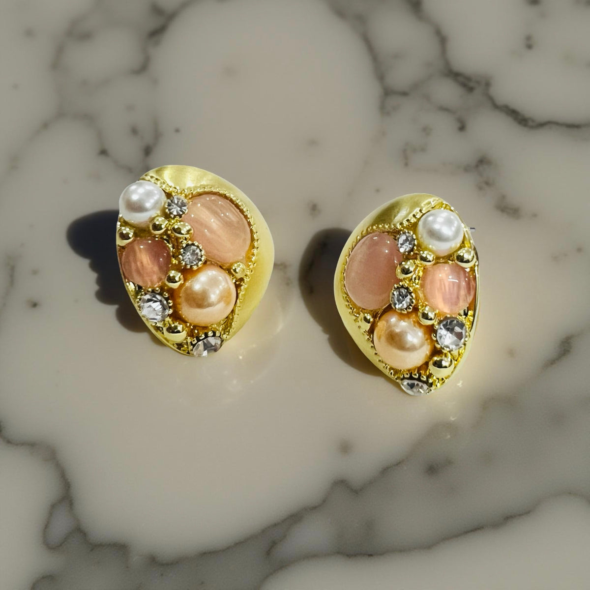Gold-plated pearl and stone cluster pendant and earrings set by Jinam, featuring elegant jewelry with intricate detailing.