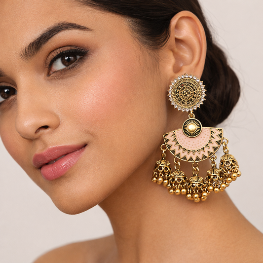 Gold-plated peach enamel dangler earrings with jhumka drops from Jinam, featuring intricate traditional design and vibrant colors.
