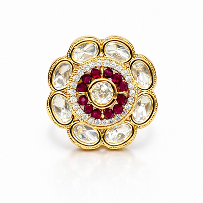 Jinam Ruby Polki floral ring in antique gold finish with intricate design and vibrant red ruby stones on a delicate band.