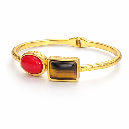 Jinam dual-stone gold bracelet with bold design and sparkling stones, showcasing elegant jewelry style.
