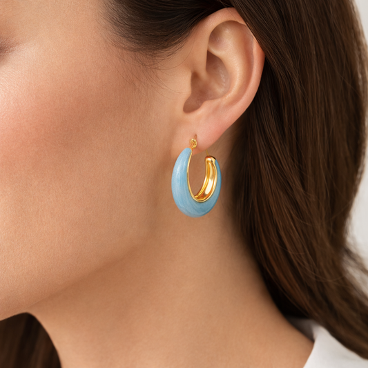 Blue enamel chunky hoop earrings by Jinam, large circular earrings with vibrant blue enamel finish and bold design.