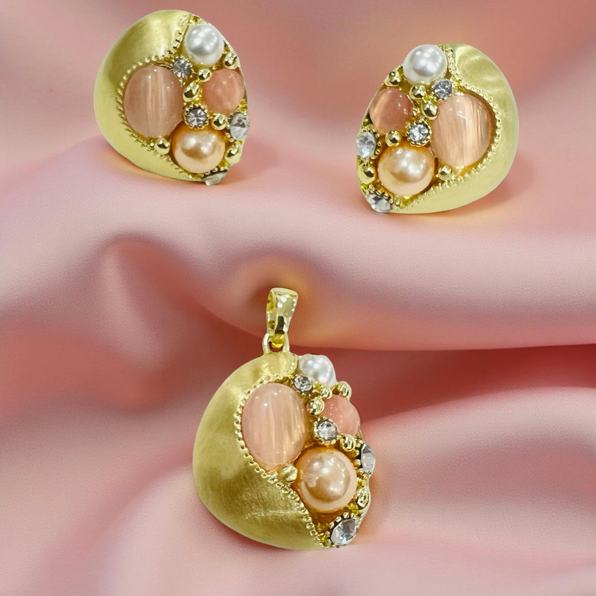 Gold-plated pearl and stone cluster pendant and earrings set by Jinam, featuring elegant jewelry with intricate details.