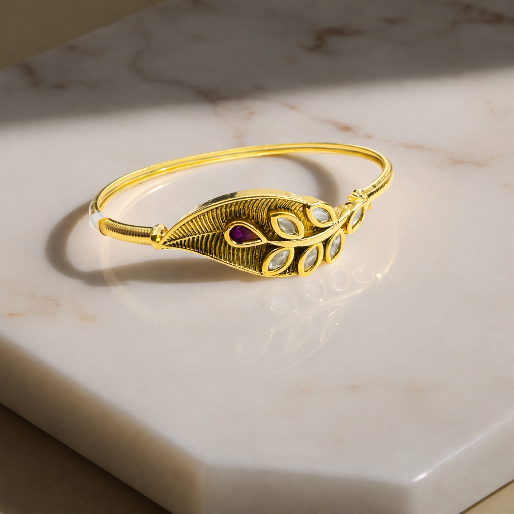 Gold-plated leaf motif Kundan bracelet with intricate design, featuring traditional craftsmanship and elegant jewelry styling.