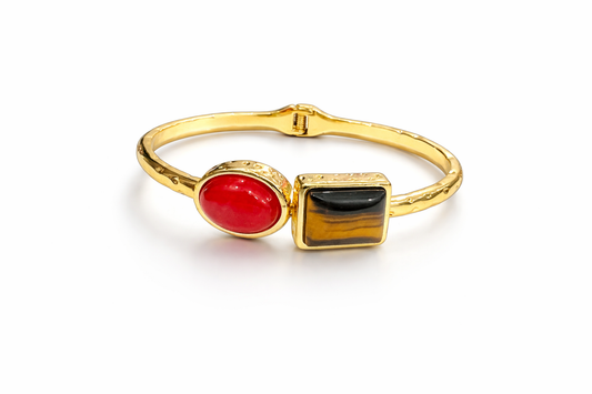 Gold bracelet with dual-stone statement design by Jinam, featuring a sleek, elegant jewelry piece with gold and stone accents.