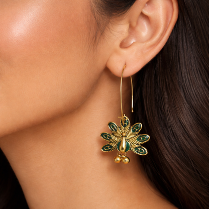 Gold-plated peacock motif hook earrings by Jinam featuring intricate antique design and elegant feather details.