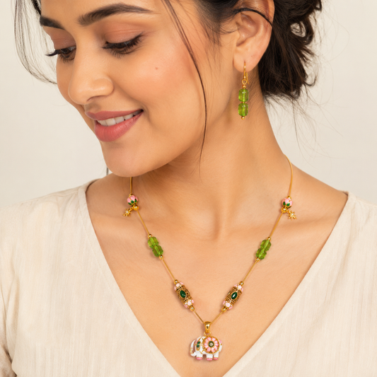 Model wearing Meenakari Elephant Pendant Necklace with green crystal earrings