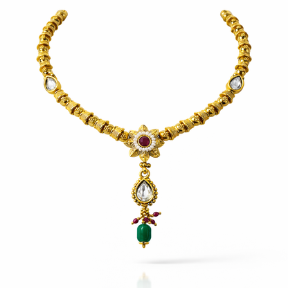 Jinam Floral Grace Ruby and Emerald Necklace set featuring a delicate floral design with vibrant gemstones and intricate metalwork.