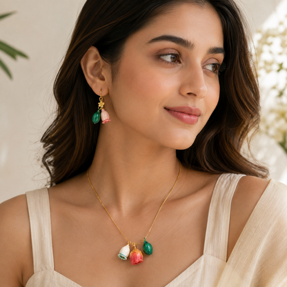 Green stone and pink floral drop earrings close up