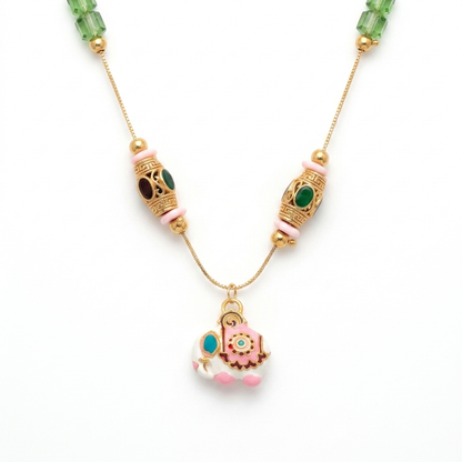 Close up of Meenakari Elephant Pendant and ornate gold Tibetan beads